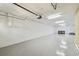 Spacious one-car garage with epoxy flooring, white walls, and ample storage space at 5014 W Lancaster St, Tampa, FL 33616