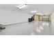 Spacious garage with epoxy floors, utility sink, and storage, offering functionality and cleanliness at 5014 W Lancaster St, Tampa, FL 33616