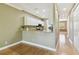 Stylish kitchen with granite countertops and a breakfast bar, seamlessly connected to the dining area at 5014 W Lancaster St, Tampa, FL 33616