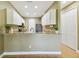 Modern kitchen with granite countertops, white cabinetry, and stainless steel appliances at 5014 W Lancaster St, Tampa, FL 33616