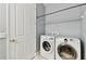 Laundry room featuring a washer and dryer, with a wire shelf for storage space at 5014 W Lancaster St, Tampa, FL 33616