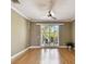 Bright living room with hardwood floors, crown molding, and sliding glass doors to the balcony at 5014 W Lancaster St, Tampa, FL 33616