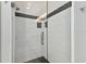 Modern shower with glass door, decorative tile accent, and updated shower head at 5014 W Lancaster St, Tampa, FL 33616