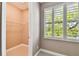 Walk-in closet with wire shelving and a window with plantation shutters at 5014 W Lancaster St, Tampa, FL 33616