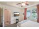 Bedroom with natural light, modern ceiling fan, and TV at 5115 Melbourne St # A303, Port Charlotte, FL 33980