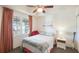 Cozy bedroom with fan, neutral walls, window, and a view at 5115 Melbourne St # A303, Port Charlotte, FL 33980