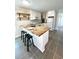 Bright kitchen with stylish island featuring butcher block countertop, white cabinets, and modern stools at 5123 5Th St, Zephyrhills, FL 33542