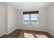 Bright bedroom features hardwood floors, neutral paint, and a window overlooking the water at 5200 Brittany S Dr # 1503, St Petersburg, FL 33715