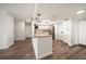 Bright kitchen with island, stainless steel appliances, granite countertops, and wood look floors at 5200 Brittany S Dr # 1503, St Petersburg, FL 33715