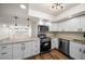 Stylish kitchen boasts stainless appliances, white cabinetry, granite counters and a view of the ocean at 5200 Brittany S Dr # 1503, St Petersburg, FL 33715