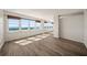 Bright living room with water views from its many large windows and wood-style flooring at 5200 Brittany S Dr # 1503, St Petersburg, FL 33715