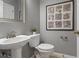 Modern half bathroom with pedestal sink, toilet, and neutral wall color at 555 52Nd N Ave, St Petersburg, FL 33703