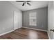 This bedroom features hardwood floors, neutral walls, ceiling fan, a window, and a double door closet at 555 52Nd N Ave, St Petersburg, FL 33703