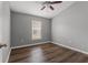 This bedroom features hardwood floors, a ceiling fan, neutral walls and natural light from a window at 555 52Nd N Ave, St Petersburg, FL 33703