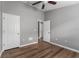 This bedroom features hardwood floors, neutral walls, ceiling fan, and white doors at 555 52Nd N Ave, St Petersburg, FL 33703