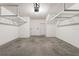 Spacious garage with white walls, concrete floors, shelving, and a white door at 555 52Nd N Ave, St Petersburg, FL 33703