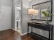 Hallway with hardwood floors, modern console table, and half bath access at 555 52Nd N Ave, St Petersburg, FL 33703