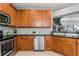 Well-lit kitchen featuring wooden cabinets, granite countertops, and stainless steel appliances at 555 52Nd N Ave, St Petersburg, FL 33703