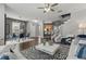 Open-concept living room and dining area with hardwood floors, modern decor, and staircase access at 555 52Nd N Ave, St Petersburg, FL 33703