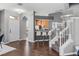 Inviting living space with hardwood floors, kitchen bar access, and modern staircase design at 555 52Nd N Ave, St Petersburg, FL 33703