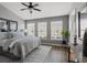 This main bedroom features hardwood floors, a ceiling fan, and three windows that provide plenty of natural light at 555 52Nd N Ave, St Petersburg, FL 33703