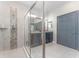 Modern bathroom with a glass-enclosed shower, vanity with double sinks, and contemporary finishes at 6002 Thrushwood Rd, Lithia, FL 33547