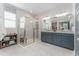 Well-appointed bathroom features a glass-enclosed shower, double vanity, and modern fixtures at 6002 Thrushwood Rd, Lithia, FL 33547