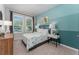 Comfortable bedroom with a queen bed, lamps, and a view from the window at 6002 Thrushwood Rd, Lithia, FL 33547