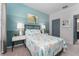 Well-lit bedroom with a queen bed, stylish lamps, and calming blue tones at 6002 Thrushwood Rd, Lithia, FL 33547