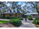 Outdoor signage and well-maintained clubhouse situated in a community surrounded by lush landscaping and nature trails at 6002 Thrushwood Rd, Lithia, FL 33547