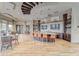The clubhouse cafe features a large island with seating, pendant lighting and views of outdoor seating and landscaping at 6002 Thrushwood Rd, Lithia, FL 33547