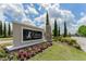 Entrance to Encore FishHawk Ranch shows a beautiful sign amongst landscaping and bright flowers under a partly cloudy sky at 6002 Thrushwood Rd, Lithia, FL 33547
