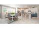 Open-concept dining area with a modern table and chairs, seamlessly connecting to the kitchen at 6002 Thrushwood Rd, Lithia, FL 33547