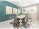 Stylish dining room boasts elegant furnishings, a modern chandelier, and a vibrant accent wall at 6002 Thrushwood Rd, Lithia, FL 33547