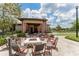 Gather around the fire pit at the community clubhouse and enjoy the outdoors in this covered patio space at 6002 Thrushwood Rd, Lithia, FL 33547