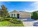 Charming single-story home featuring manicured landscaping, a two-car garage, and a welcoming front porch at 6002 Thrushwood Rd, Lithia, FL 33547