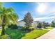 Attractive home exterior featuring a well-kept lawn, mature landscaping, and a convenient two-car garage at 6002 Thrushwood Rd, Lithia, FL 33547