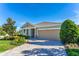 Beautifully landscaped single-story home with a well-manicured lawn and a two-car garage at 6002 Thrushwood Rd, Lithia, FL 33547