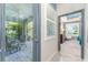 Hallway offers views of a covered lanai and a serene bedroom with ample natural light at 6002 Thrushwood Rd, Lithia, FL 33547