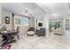 Open concept living space featuring tile flooring, light walls, a ceiling fan, and comfortable seating at 6002 Thrushwood Rd, Lithia, FL 33547