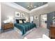 Serene main bedroom with a chandelier and connecting door at 6002 Thrushwood Rd, Lithia, FL 33547