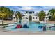 A pool with water features and a slide invites families to enjoy aquatic activities in the community's pool at 6002 Thrushwood Rd, Lithia, FL 33547