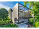 Exterior view of a screened patio with a lush green lawn and landscaping at 6002 Thrushwood Rd, Lithia, FL 33547