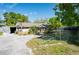 Quaint single-story home with a gravel driveway and overgrown landscaping in need of some love at 604 5Th Se Ave, Ruskin, FL 33570