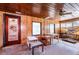 Enclosed sunroom featuring rustic wood-paneled walls and ceiling, awaiting renovation at 604 5Th Se Ave, Ruskin, FL 33570