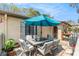 Relaxing outdoor patio features a table with seating and a large sun umbrella at 6262 142Nd N Ave # 904, Clearwater, FL 33760