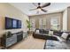 A well-lit living room featuring a ceiling fan and large windows, with a modern leather sectional at 7001 Interbay Blvd # 290, Tampa, FL 33616