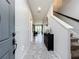 Open entryway showing stairs, hallway, and tile flooring, leading towards the living room at 7124 Summer Holly Pl, Riverview, FL 33578