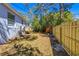 A spacious backyard featuring a newly constructed wooden fence and lush, mature trees at 750 E Harbor S Dr, St Petersburg, FL 33705