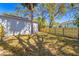 A view of the backyard with new fence, trees, and a house in the background at 750 E Harbor S Dr, St Petersburg, FL 33705